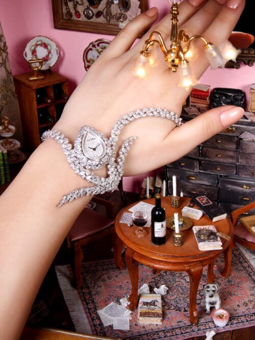 Yeprem Watches Photoshoot by Paradis Socials - Women's Diamond watch on a models hand with a miniature to life concept and pink background - paradissocials.com - Andrew Atamian